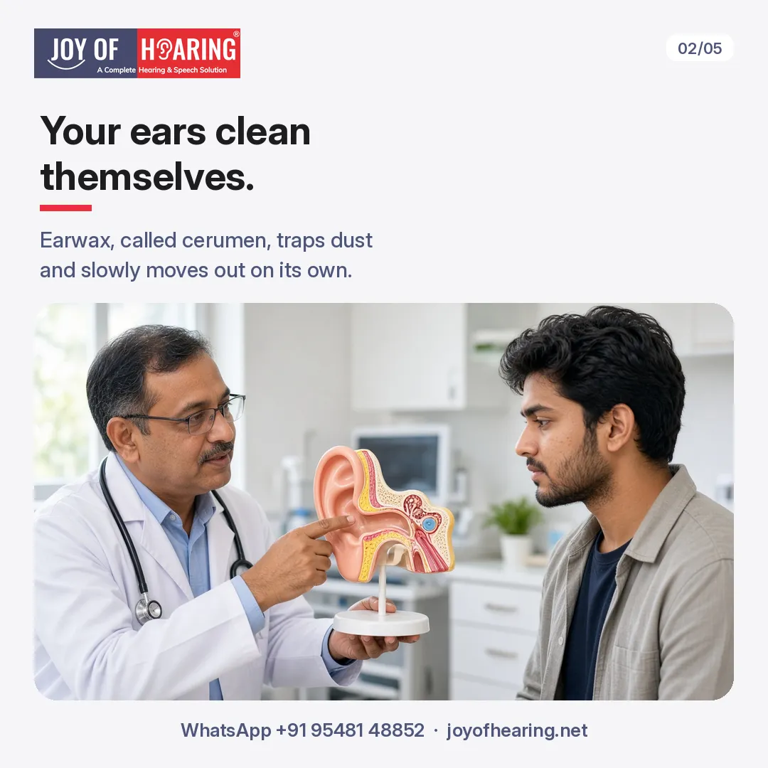 A doctor in a white coat points to a cross-section ear model while explaining to a young man.